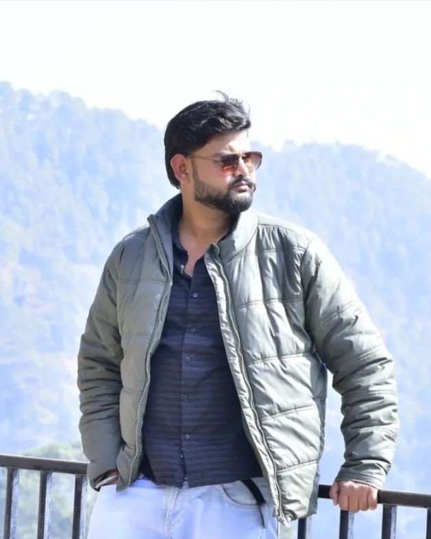 Smiling young man with curly hair and hat on his head